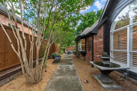 a view of a patio with table and chairs with wooden fence and plants