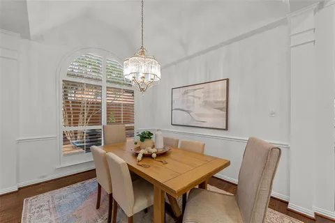 a view of a dining room with furniture wooden floor and chandelier