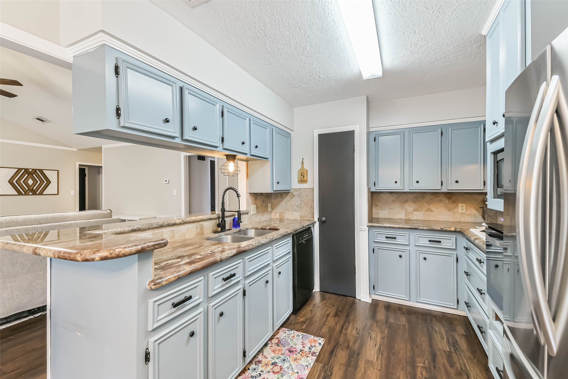 29319 Binefield Street Spring, TX 77386 - Photo 15 of 32 a kitchen with a sink stove and refrigerator