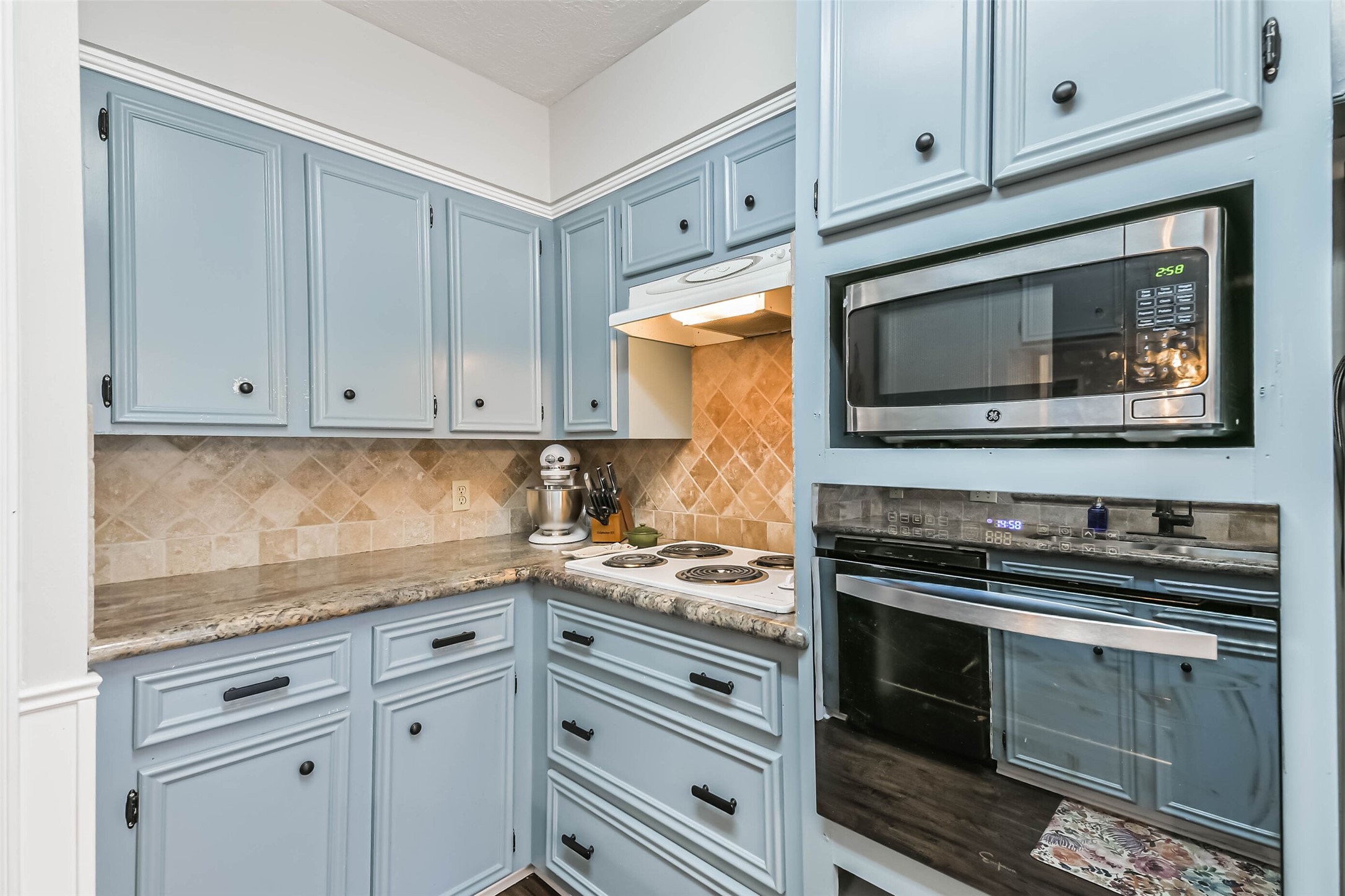 29319 Binefield Street Spring, TX 77386 - Photo 17 of 32 a kitchen with granite countertop white cabinets and stainless steel appliances