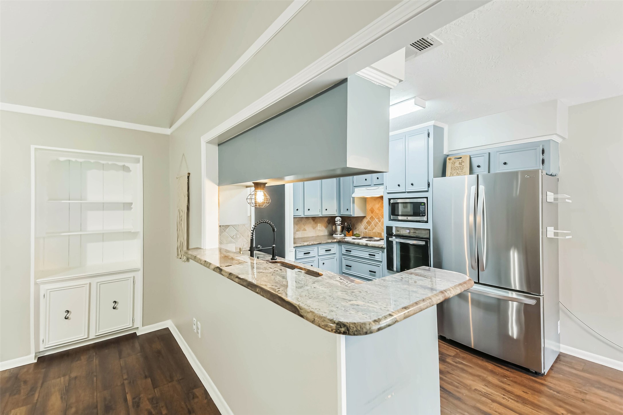 29319 Binefield Street Spring, TX 77386 - Photo 18 of 32 a kitchen with stainless steel appliances granite countertop a refrigerator and a stove top oven