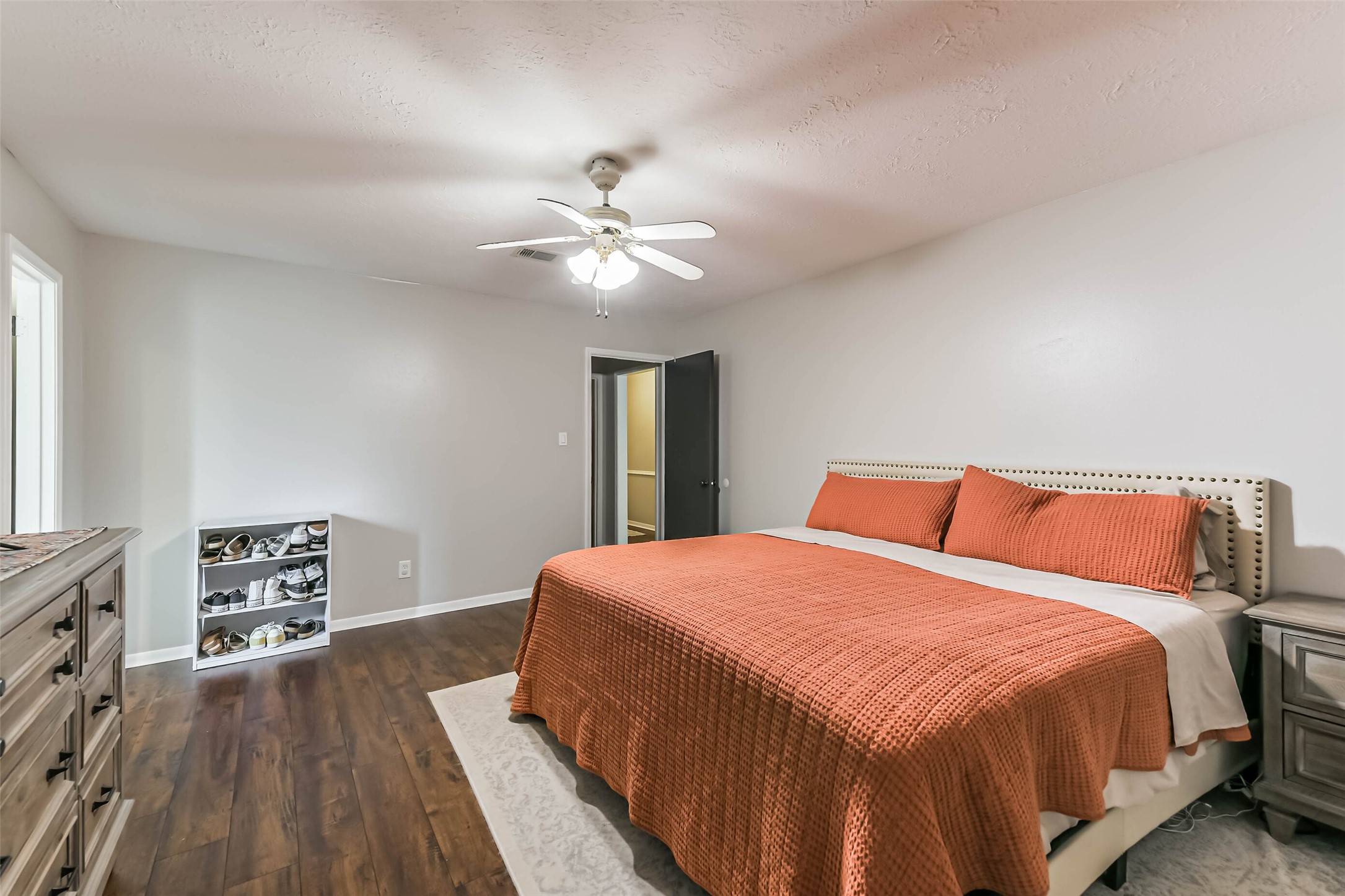 29319 Binefield Street Spring, TX 77386 - Photo 20 of 32 a bedroom with a large bed chandelier and a window