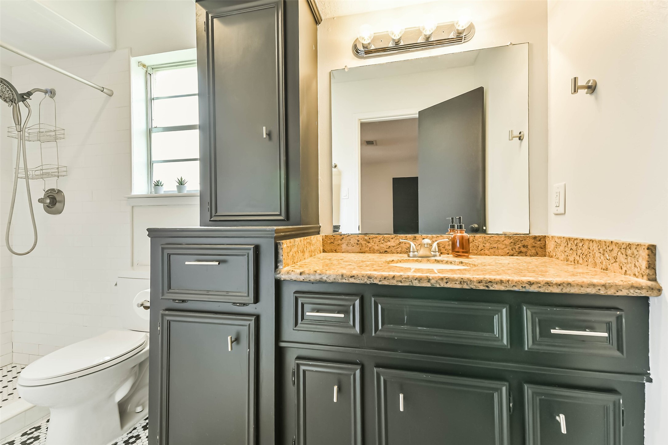 29319 Binefield Street Spring, TX 77386 - Photo 21 of 32 a bathroom with a granite countertop toilet sink and mirror