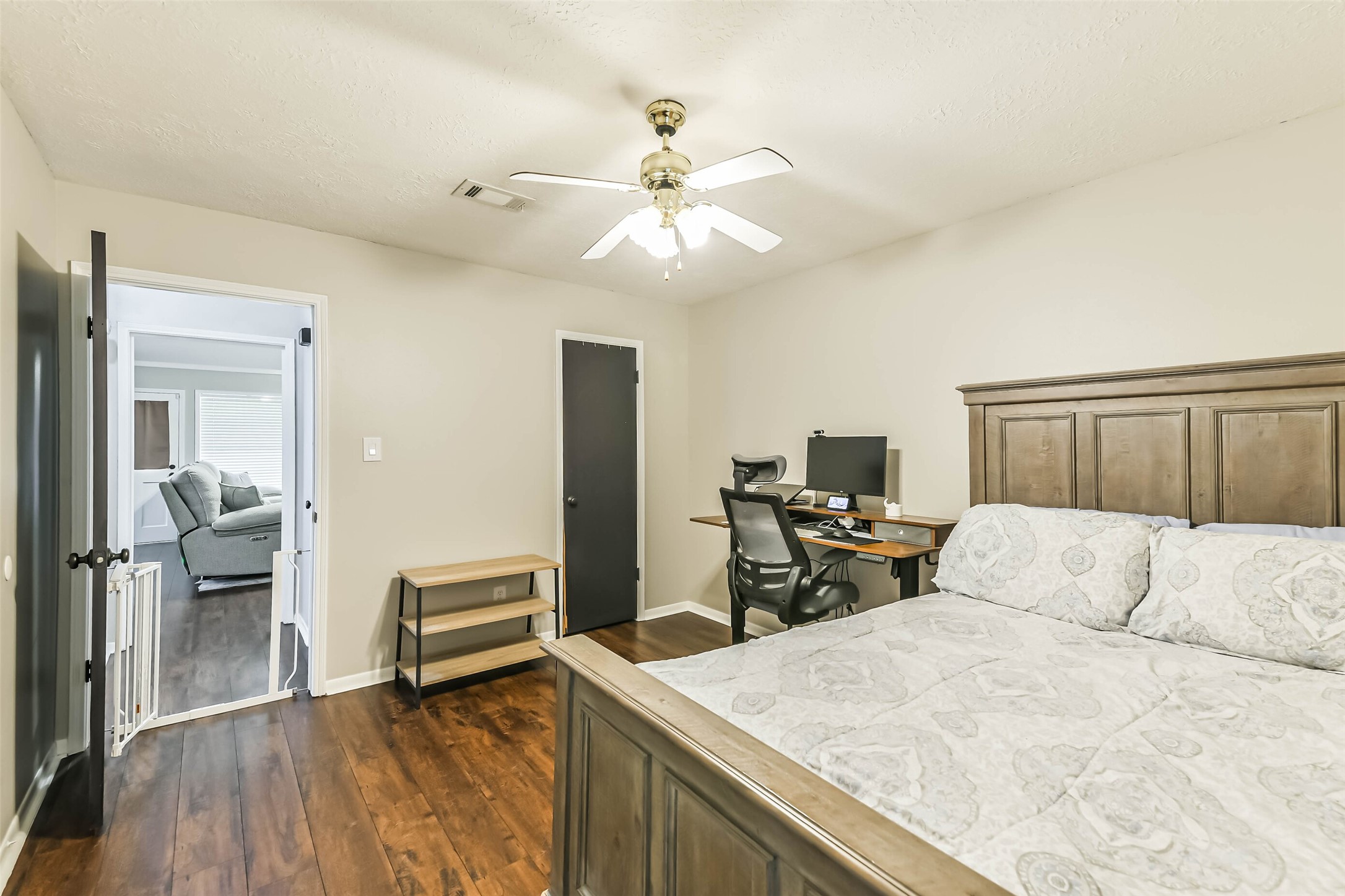 29319 Binefield Street Spring, TX 77386 - Photo 27 of 32 a bedroom with a bed and a chandelier