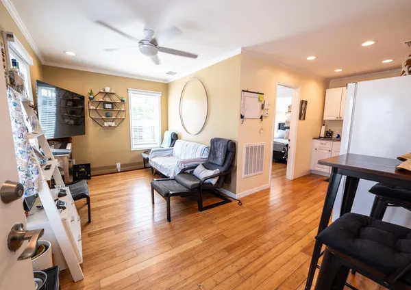 a living room with furniture a window and a flat screen tv