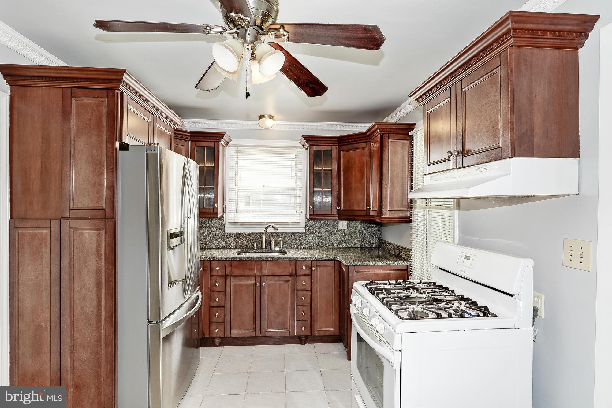7925 Liberty Road Baltimore, MD 21244 - Photo 11 of 30 a kitchen with stainless steel appliances granite countertop a refrigerator a sink dishwasher a stove and a refrigerator