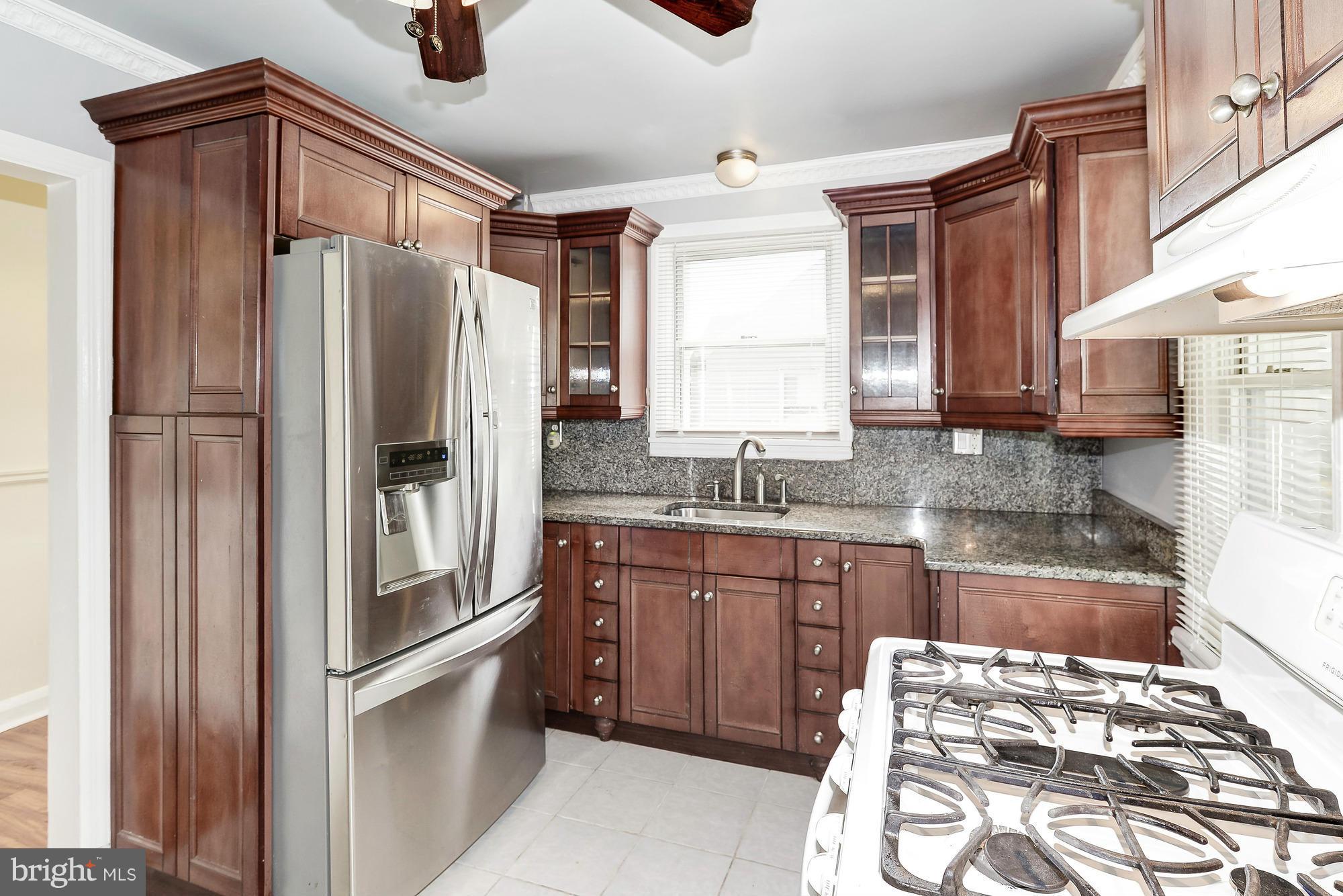 7925 Liberty Road Baltimore, MD 21244 - Photo 13 of 30 a kitchen with a refrigerator and a sink