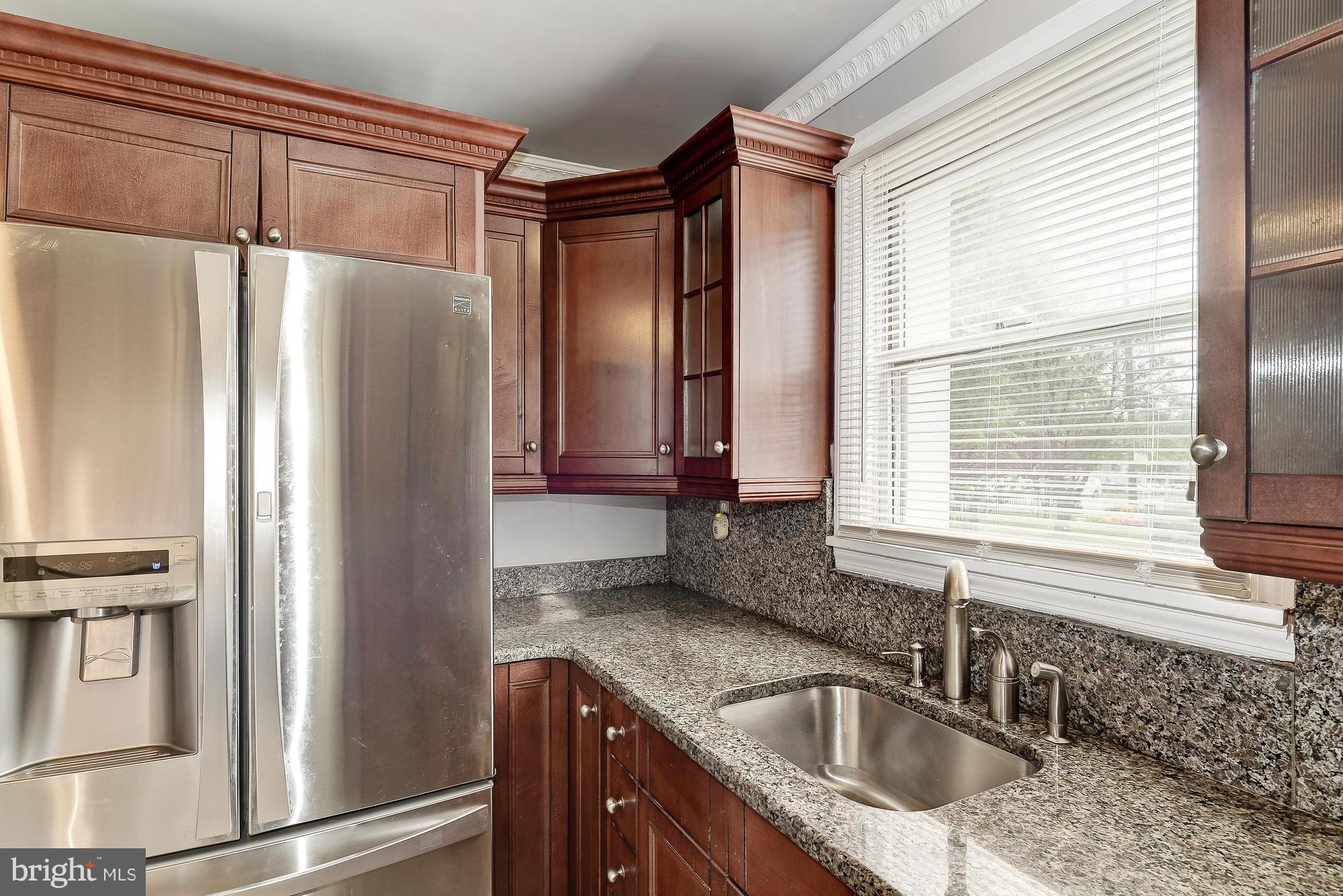 7925 Liberty Road Baltimore, MD 21244 - Photo 14 of 30 a kitchen with stainless steel appliances granite countertop a refrigerator and a sink