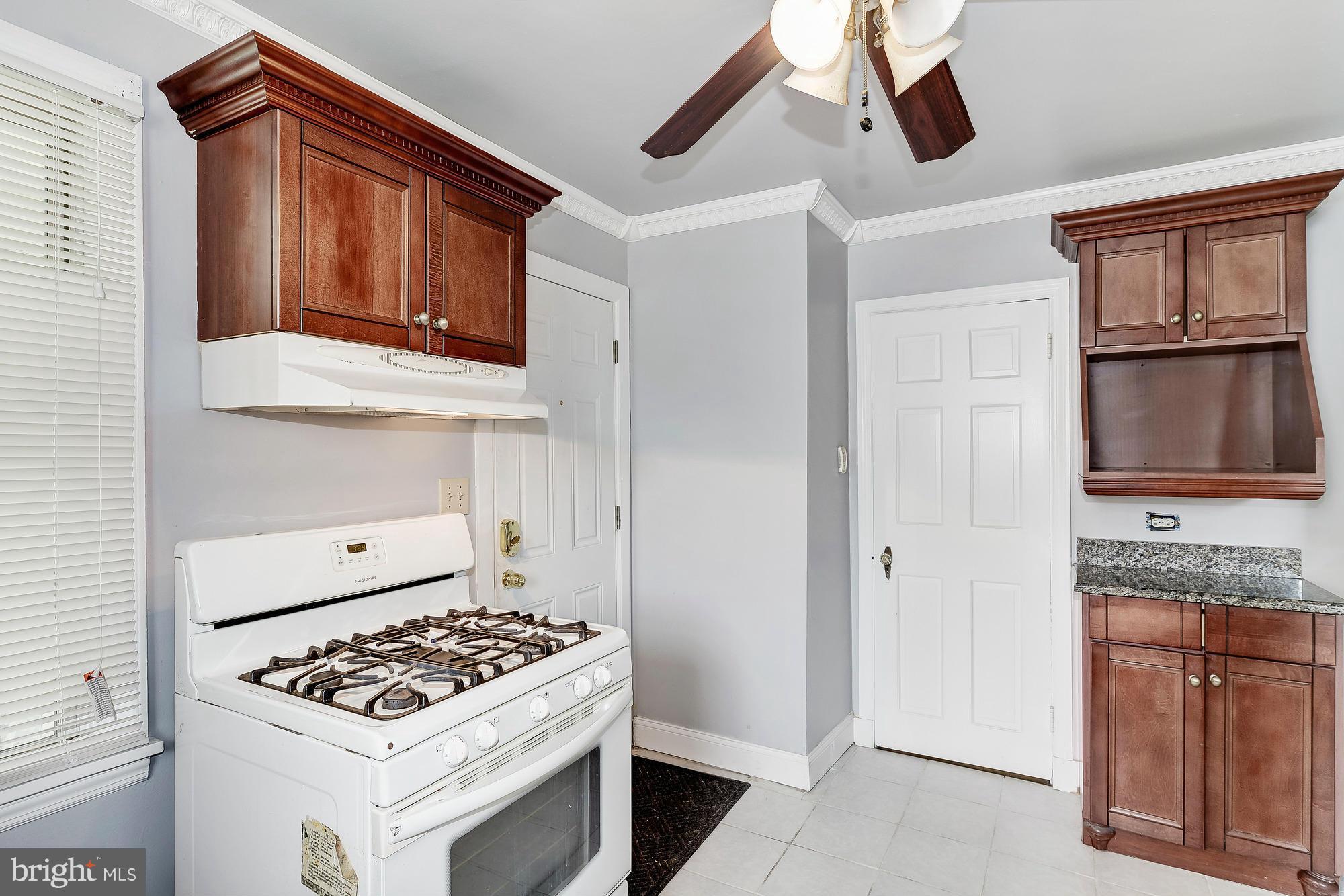 7925 Liberty Road Baltimore, MD 21244 - Photo 15 of 30 a kitchen with stainless steel appliances granite countertop a stove a sink and a microwave