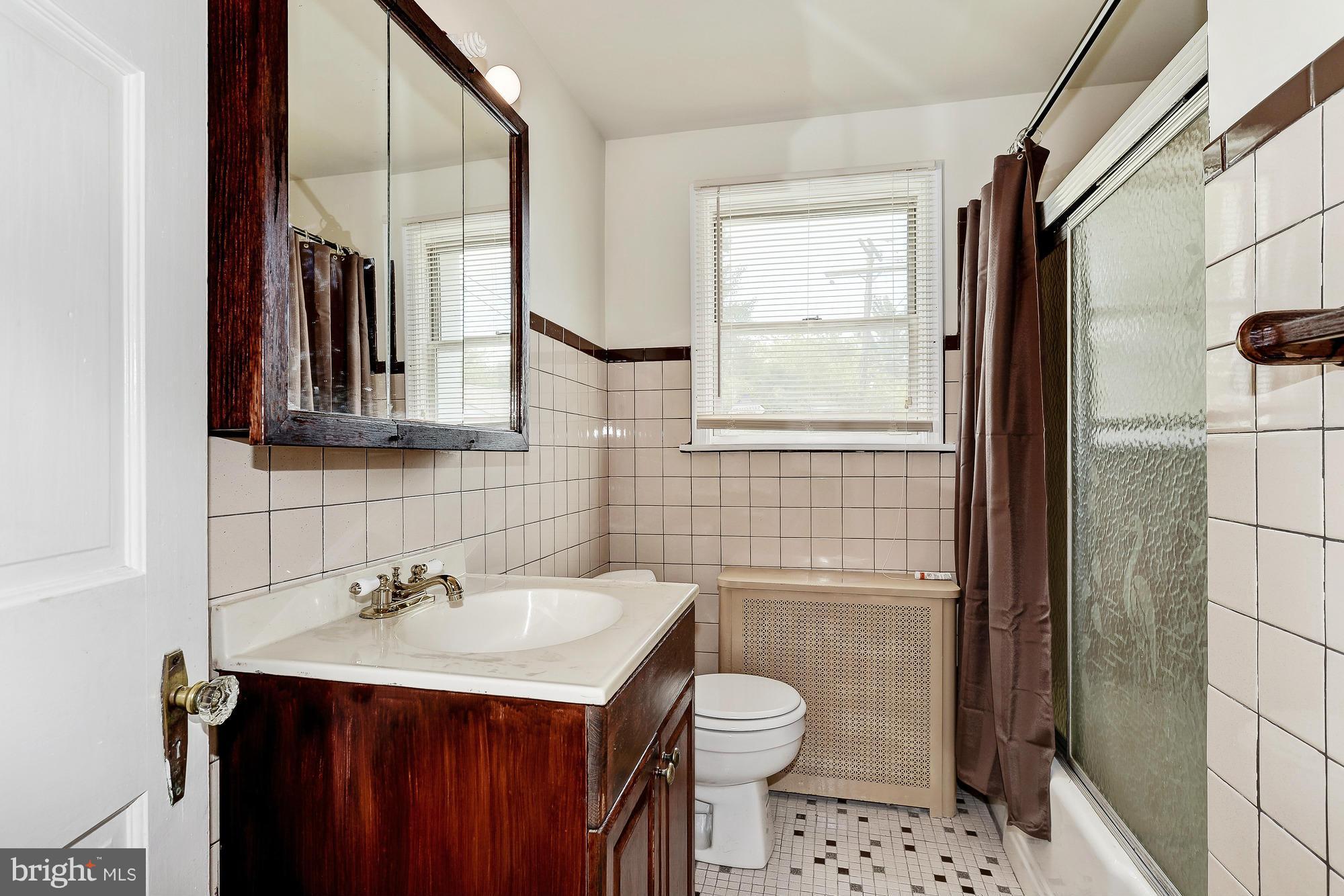 7925 Liberty Road Baltimore, MD 21244 - Photo 19 of 30 a bathroom with a sink a toilet and shower