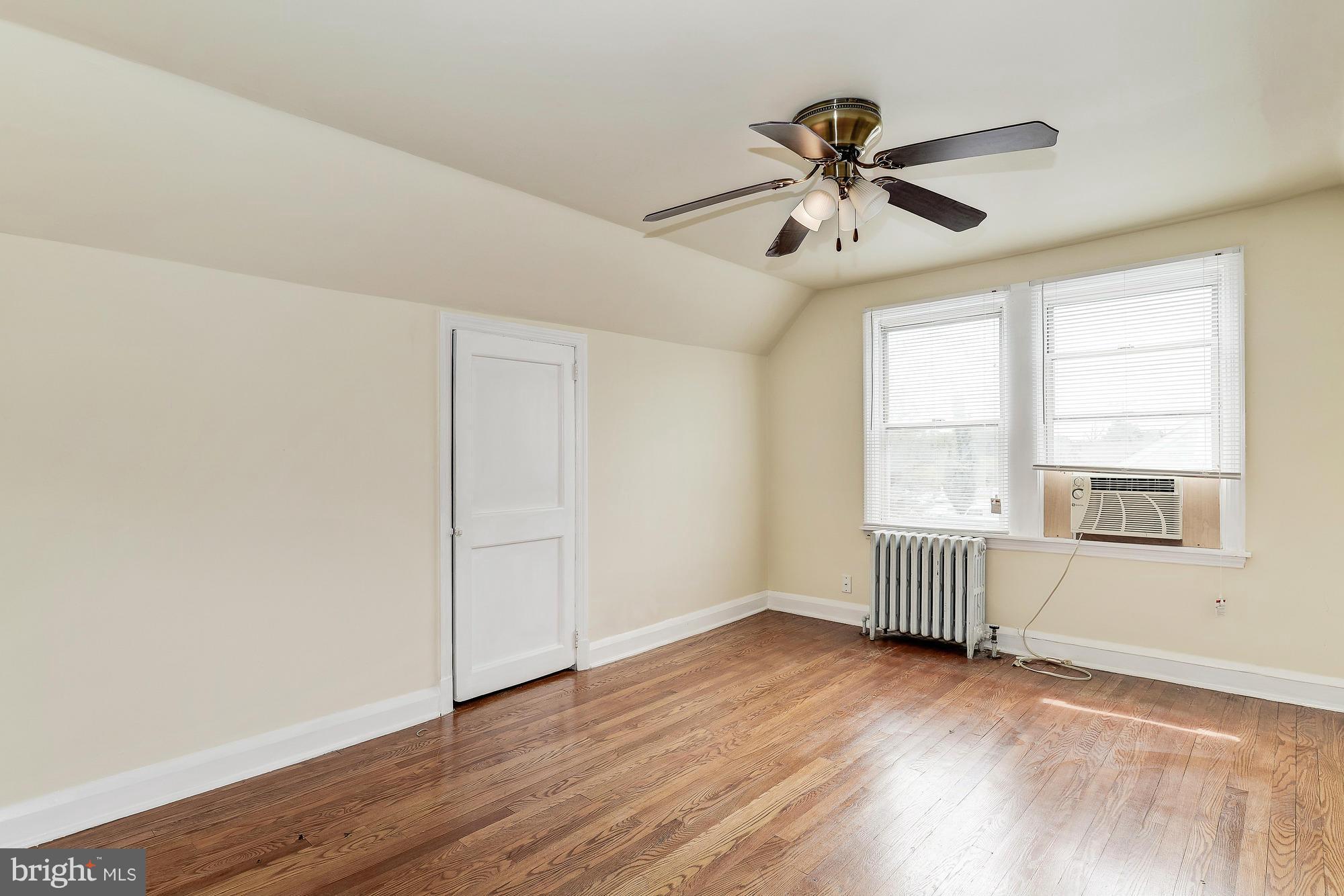 7925 Liberty Road Baltimore, MD 21244 - Photo 20 of 30 an empty room with wooden floor windows and fan