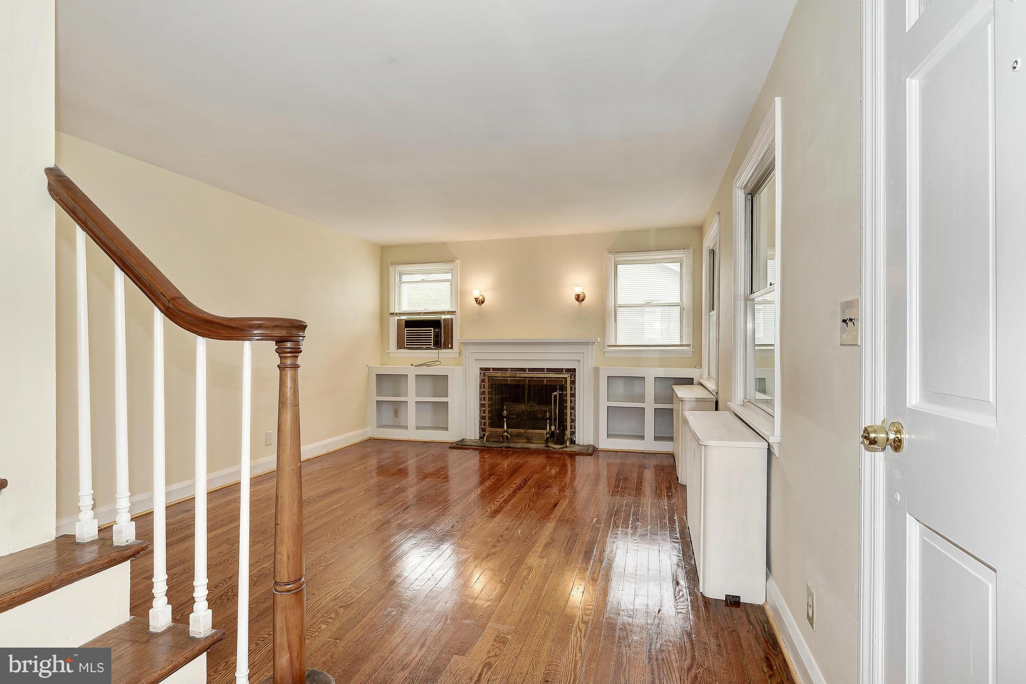 7925 Liberty Road Baltimore, MD 21244 - Photo 3 of 30 a view of a livingroom with wooden floor and a fireplace