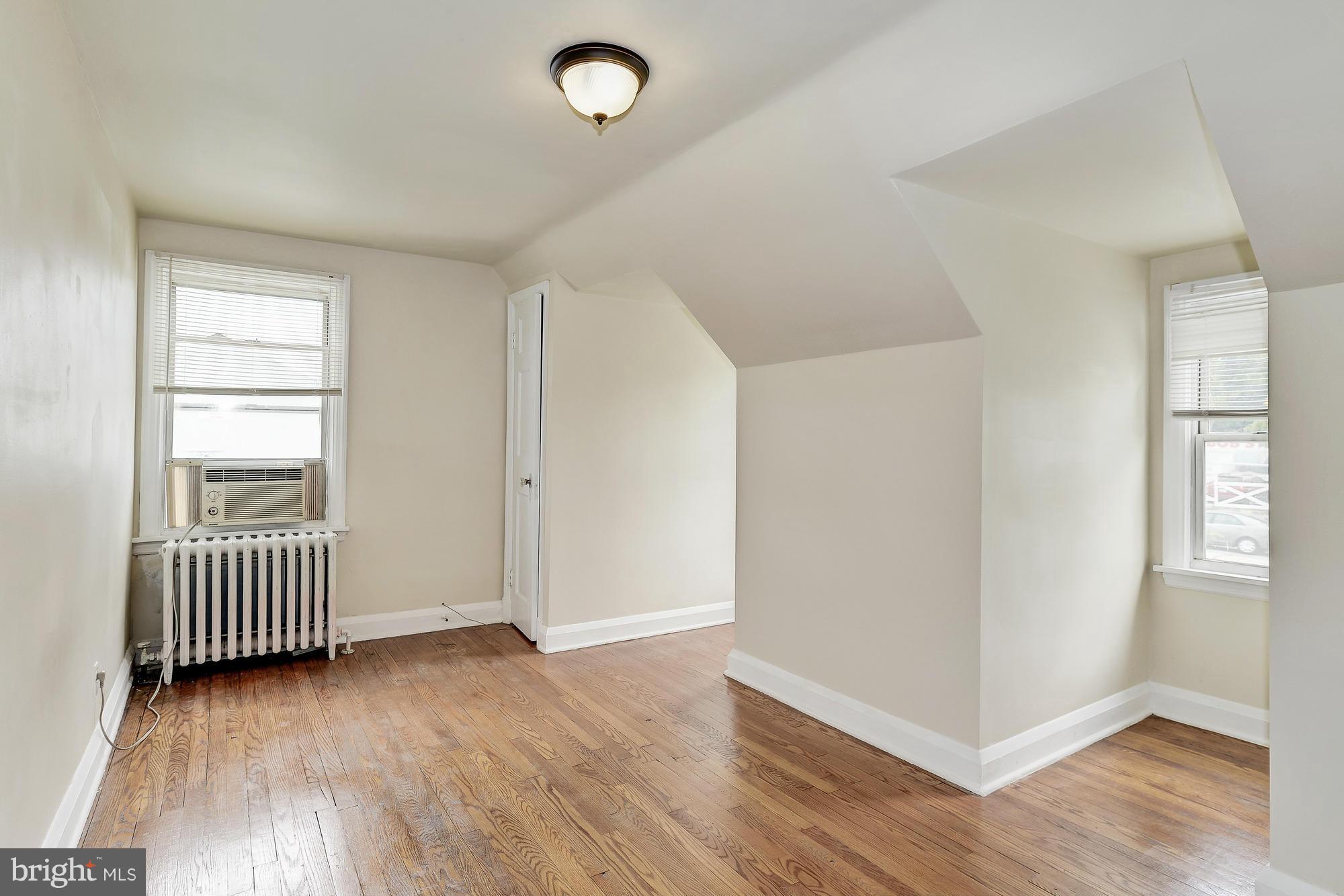 7925 Liberty Road Baltimore, MD 21244 - Photo 23 of 30 an empty room with wooden floor and windows