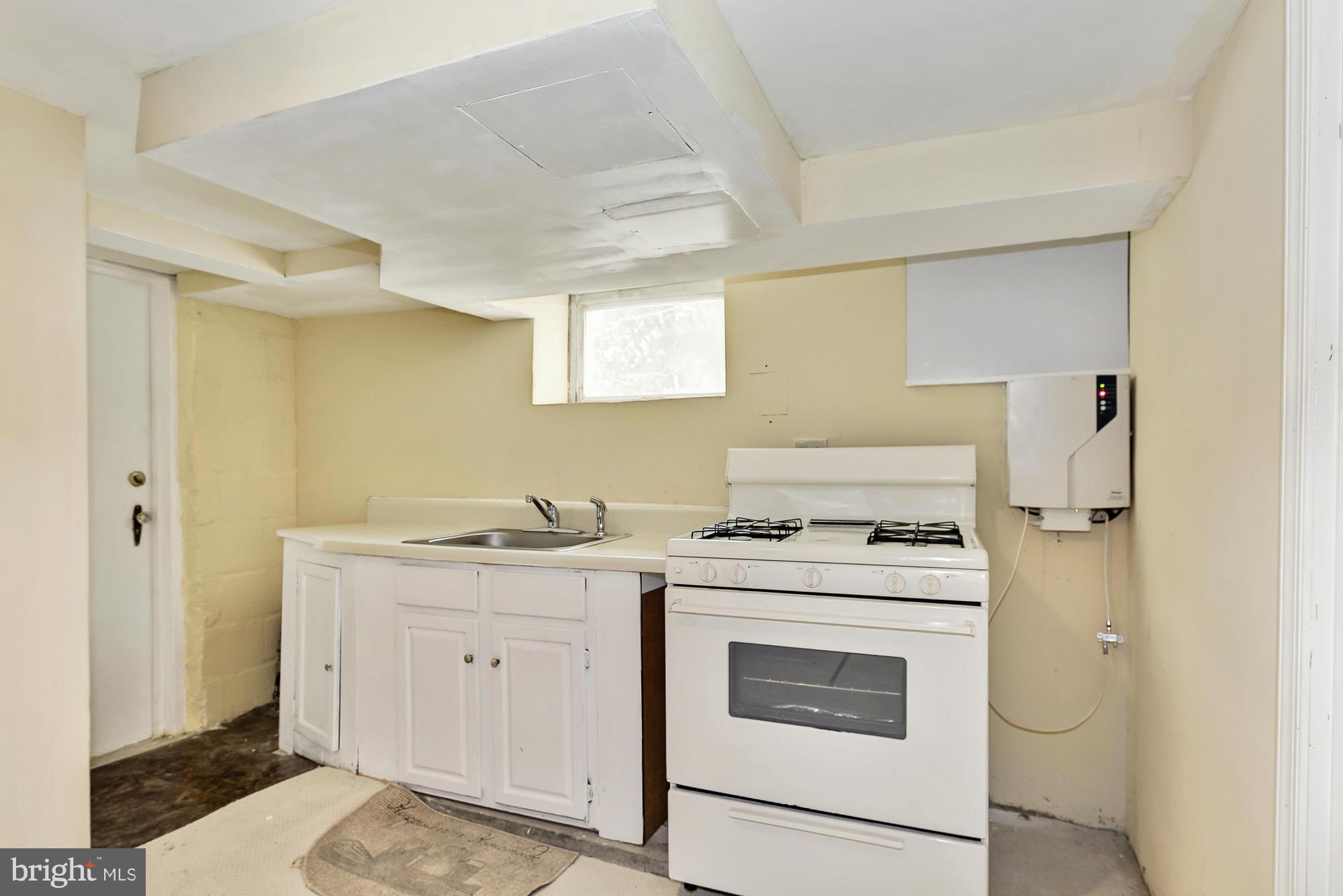 7925 Liberty Road Baltimore, MD 21244 - Photo 27 of 30 a kitchen with a stove top oven sink and cabinets