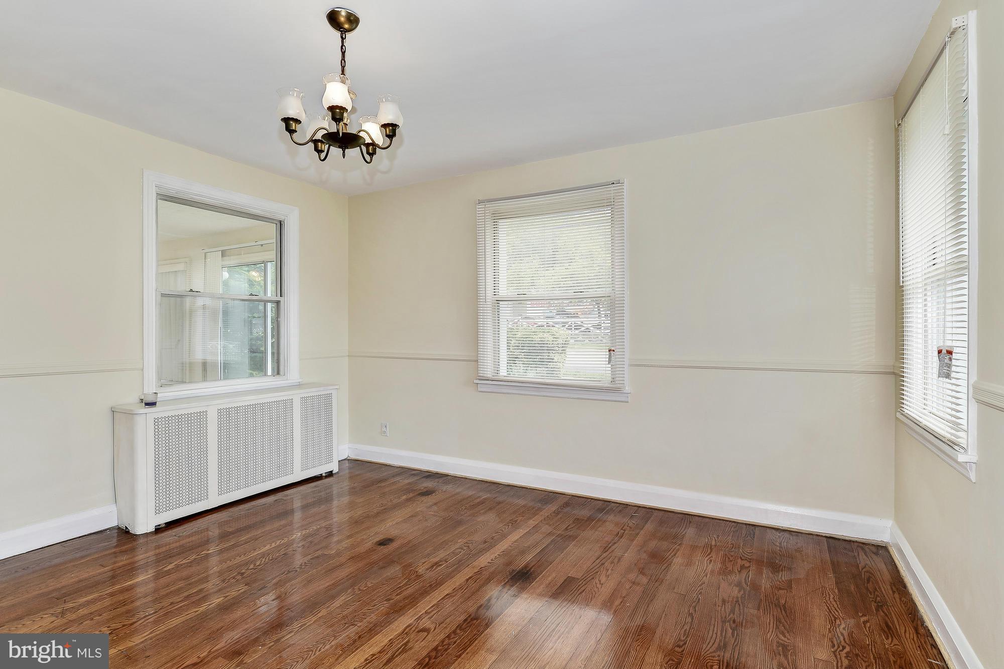 7925 Liberty Road Baltimore, MD 21244 - Photo 8 of 30 a view of an empty room with wooden floor and a window
