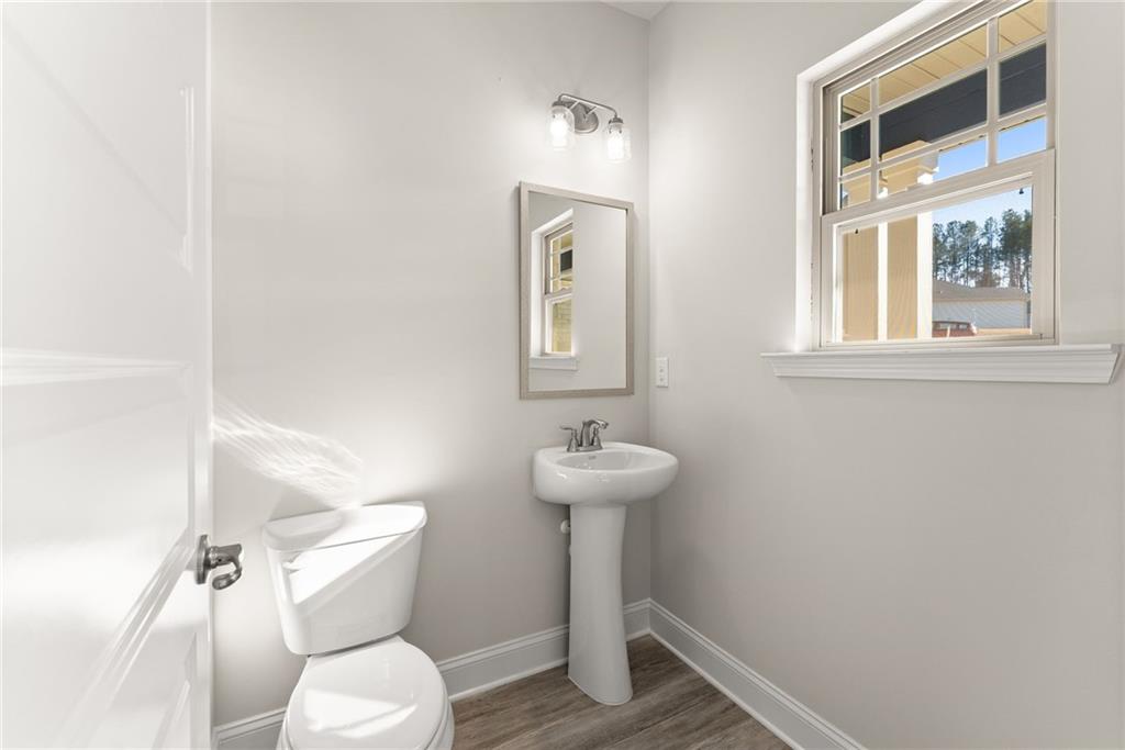 662 Forest Way Cornelia, GA 30531 - Photo 12 of 54 a bathroom with a toilet a sink and mirror