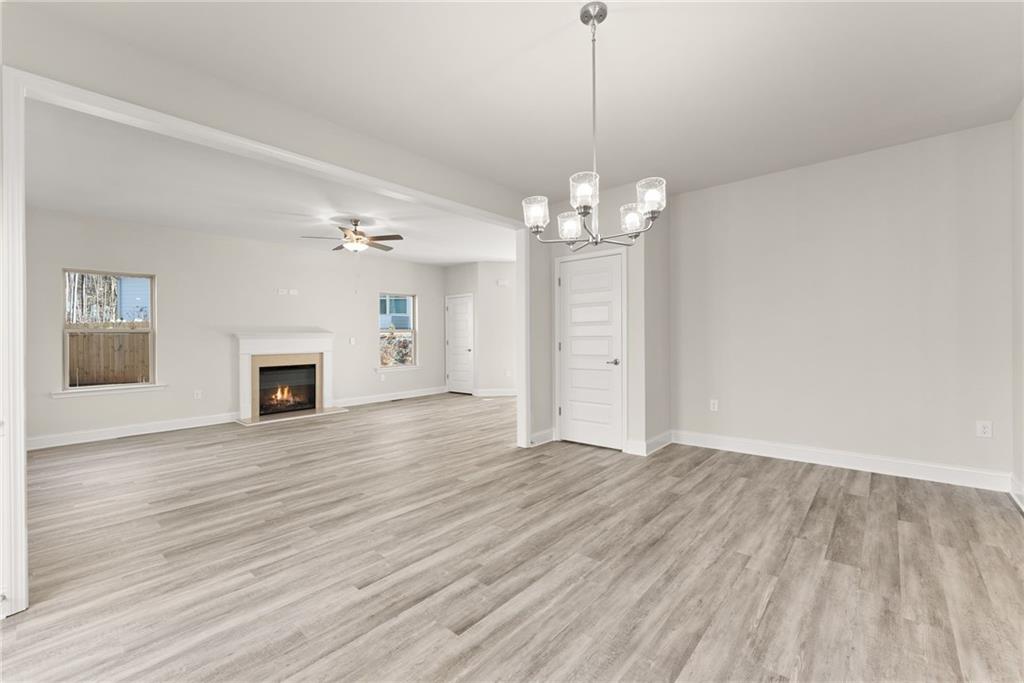 662 Forest Way Cornelia, GA 30531 - Photo 14 of 54 a view of empty room with wooden floor and fireplace