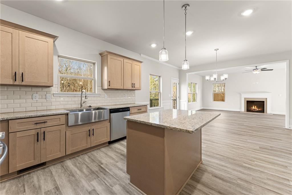 662 Forest Way Cornelia, GA 30531 - Photo 17 of 54 a kitchen with stainless steel appliances granite countertop hardwood floor sink stove and wooden cabinets