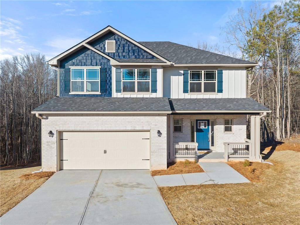 662 Forest Way Cornelia, GA 30531 - Photo 2 of 54 a front view of a house with a yard and garage