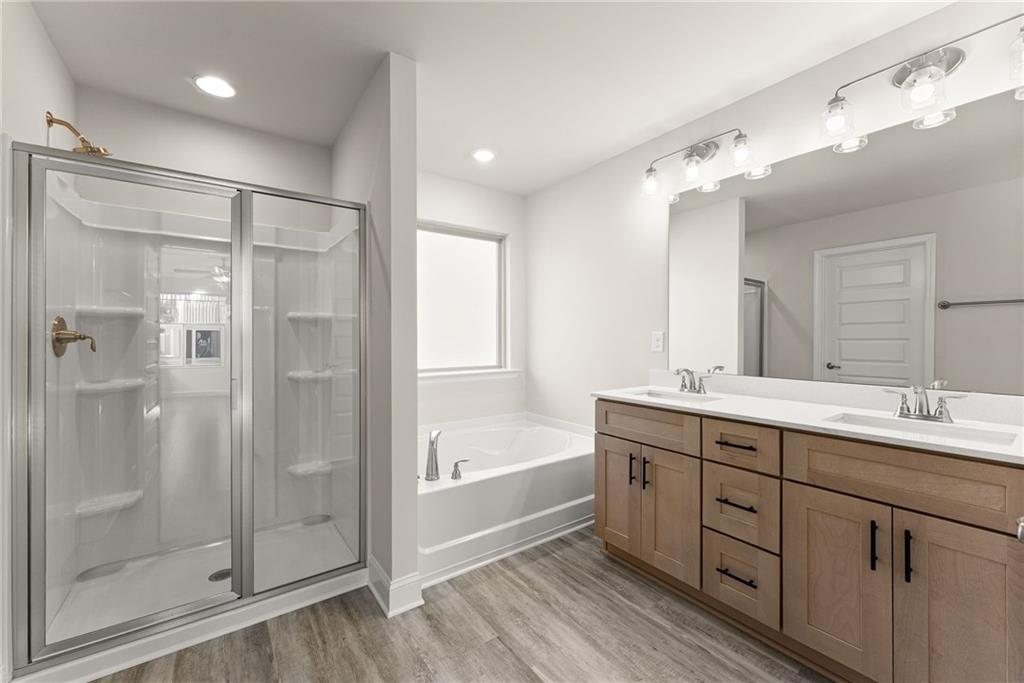 662 Forest Way Cornelia, GA 30531 - Photo 24 of 54 a bathroom with a double vanity sink mirror and shower