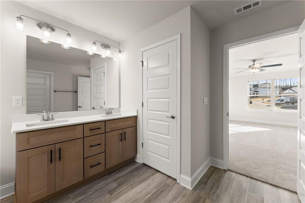 662 Forest Way Cornelia, GA 30531 - Photo 25 of 54 a spacious bathroom with a double vanity sink and mirror