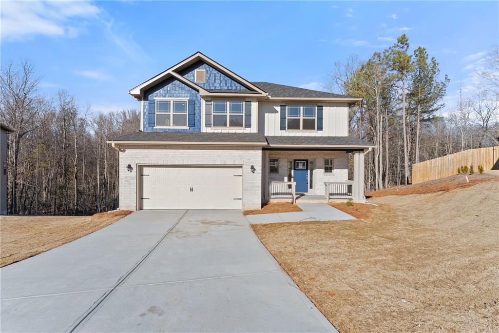 662 Forest Way Cornelia, GA 30531 - Photo 5 of 54 a front view of a house with a yard and garage