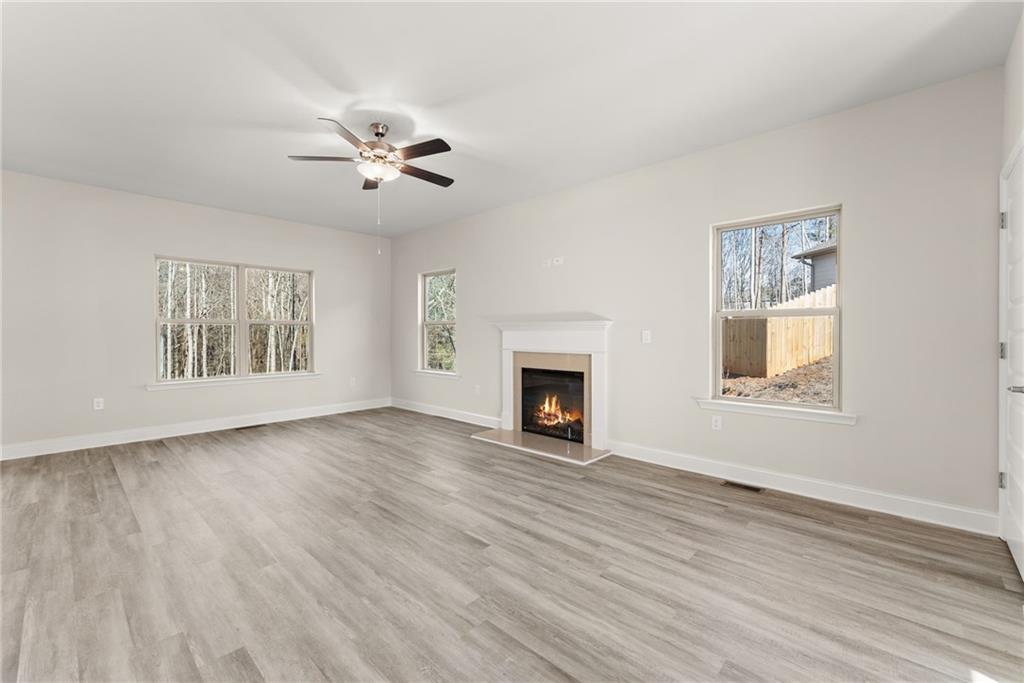 662 Forest Way Cornelia, GA 30531 - Photo 9 of 54 a view of an empty room with a fireplace and a window