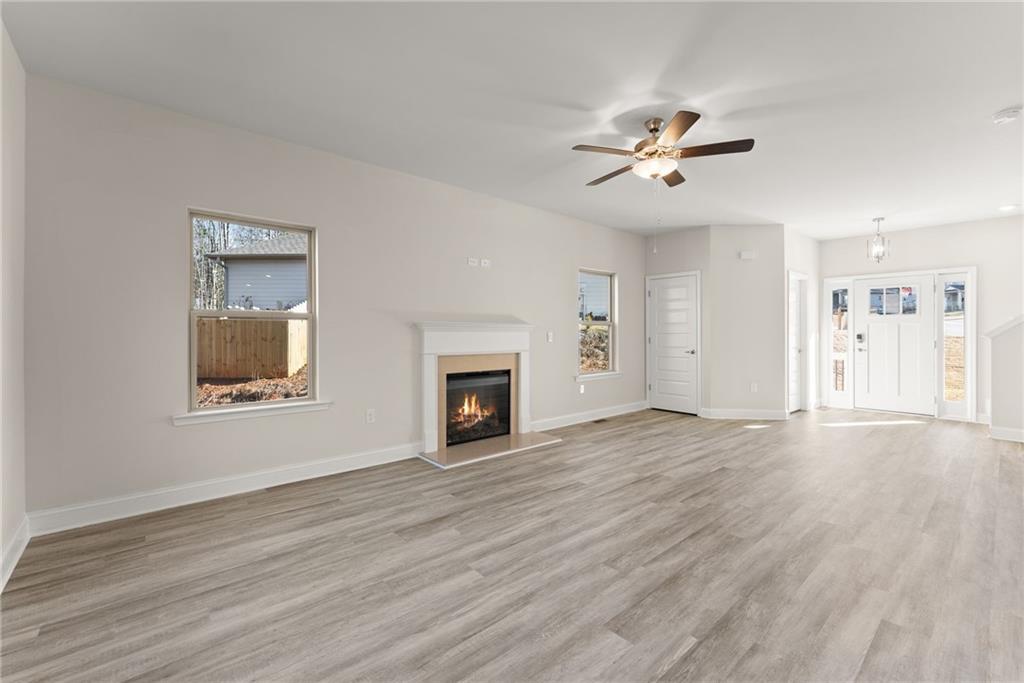 662 Forest Way Cornelia, GA 30531 - Photo 10 of 54 a view of empty room with wooden floor and fan