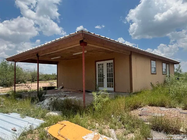 a backyard of a house with yard barbeque oven and outdoor seating