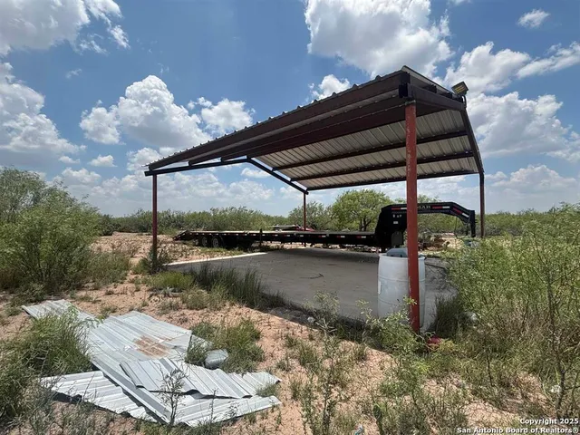a roof deck with table and chairs under an umbrella