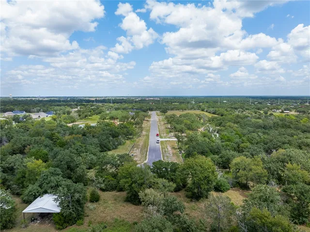 a view of a lake with houses in back