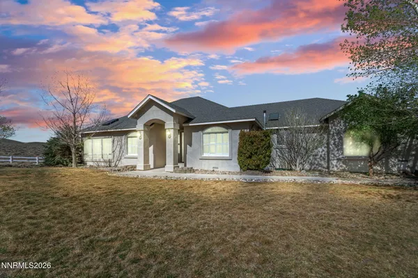 a big house with a big yard and large trees