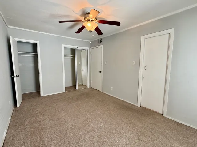 a bathroom with a toilet a sink a mirror a bathtub and vanity