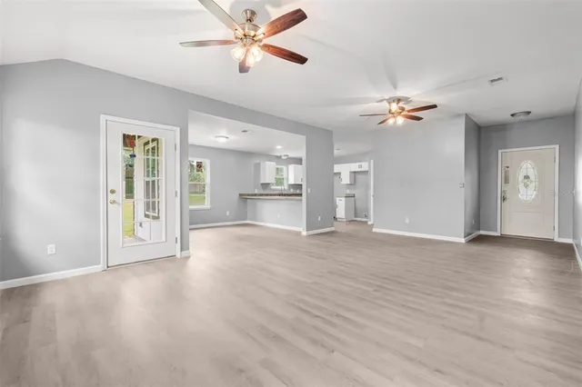 a view of an empty room with a ceiling fan