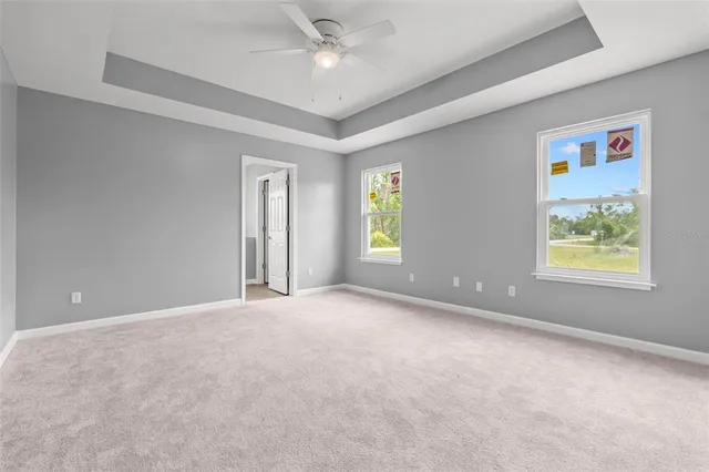 a view of an empty room with a ceiling fan