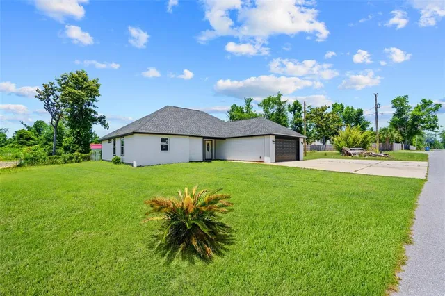 a front view of house with a garden