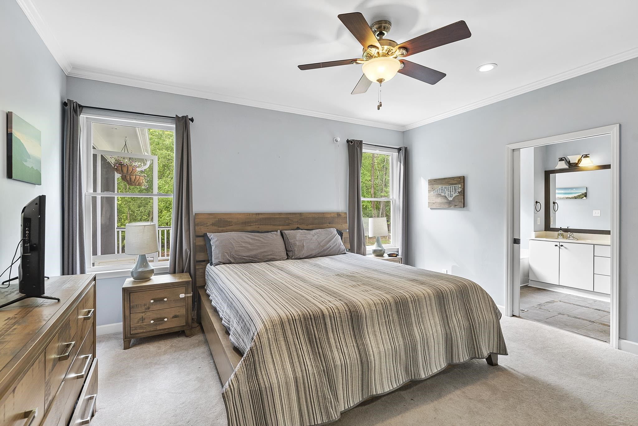 15 Otters Run Durham, NC 27712 - Photo 15 of 46 a bedroom with a bed a window and a chandelier