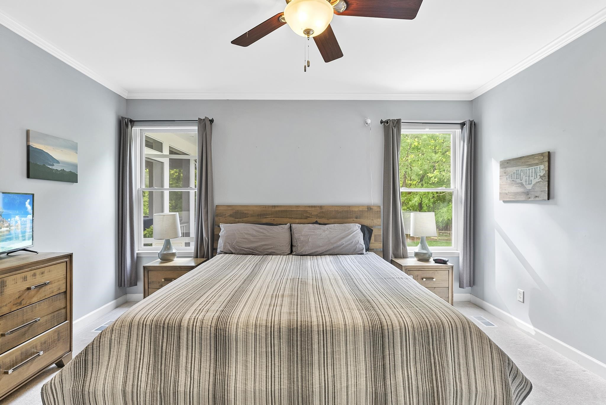 15 Otters Run Durham, NC 27712 - Photo 16 of 46 a bedroom with a large bed and a chandelier