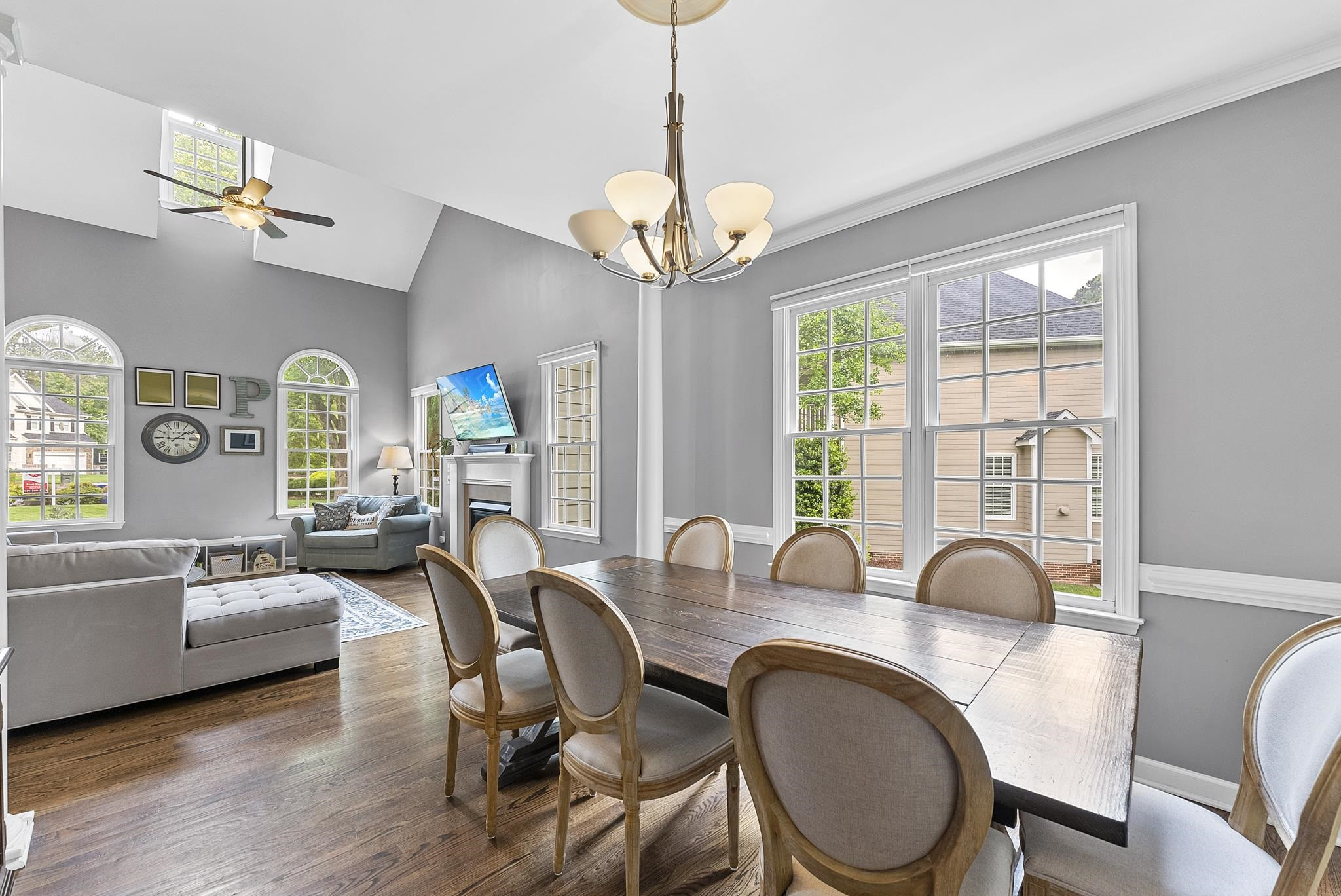 15 Otters Run Durham, NC 27712 - Photo 8 of 46 a dining room with wooden floor a chandelier a wooden table and chairs