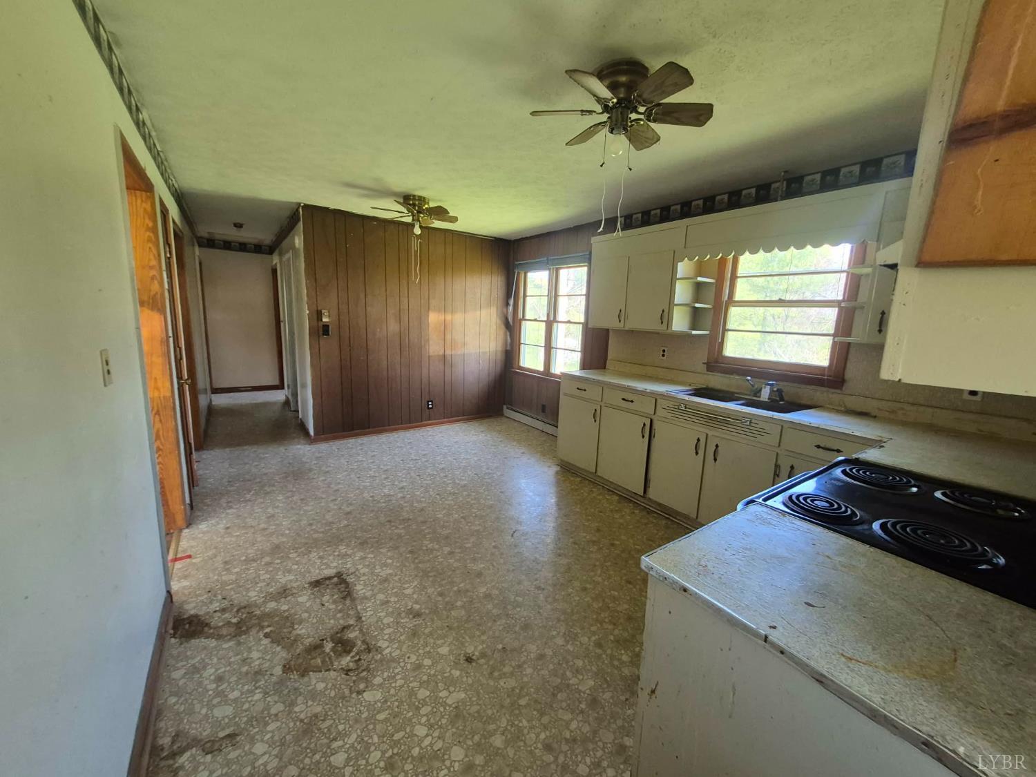 1165 Irving Road Thaxton, VA 24174 - Photo 13 of 20 a kitchen with stainless steel appliances granite countertop a sink a stove and a refrigerator