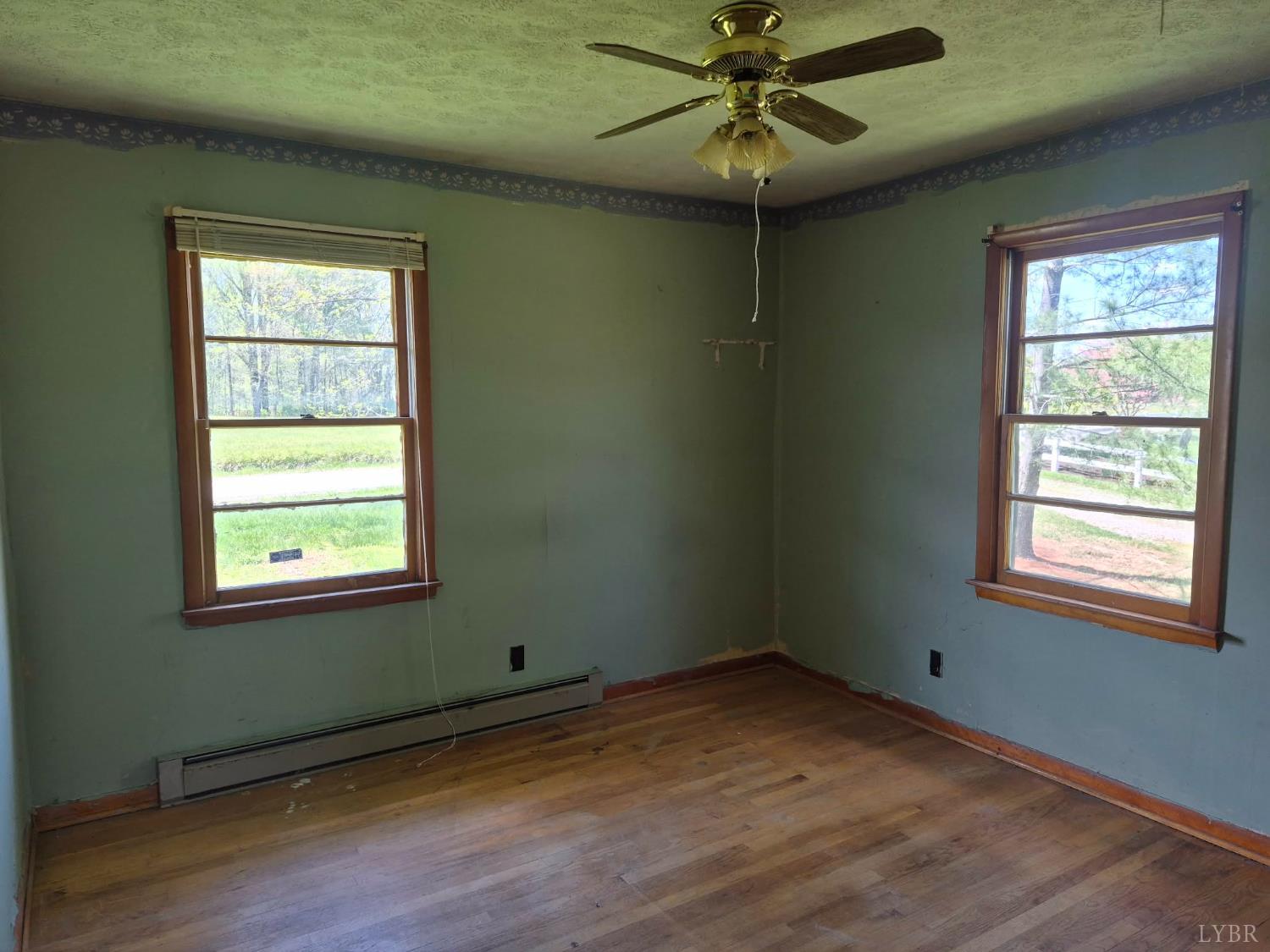 1165 Irving Road Thaxton, VA 24174 - Photo 17 of 20 a view of an empty room with wooden floor and a window