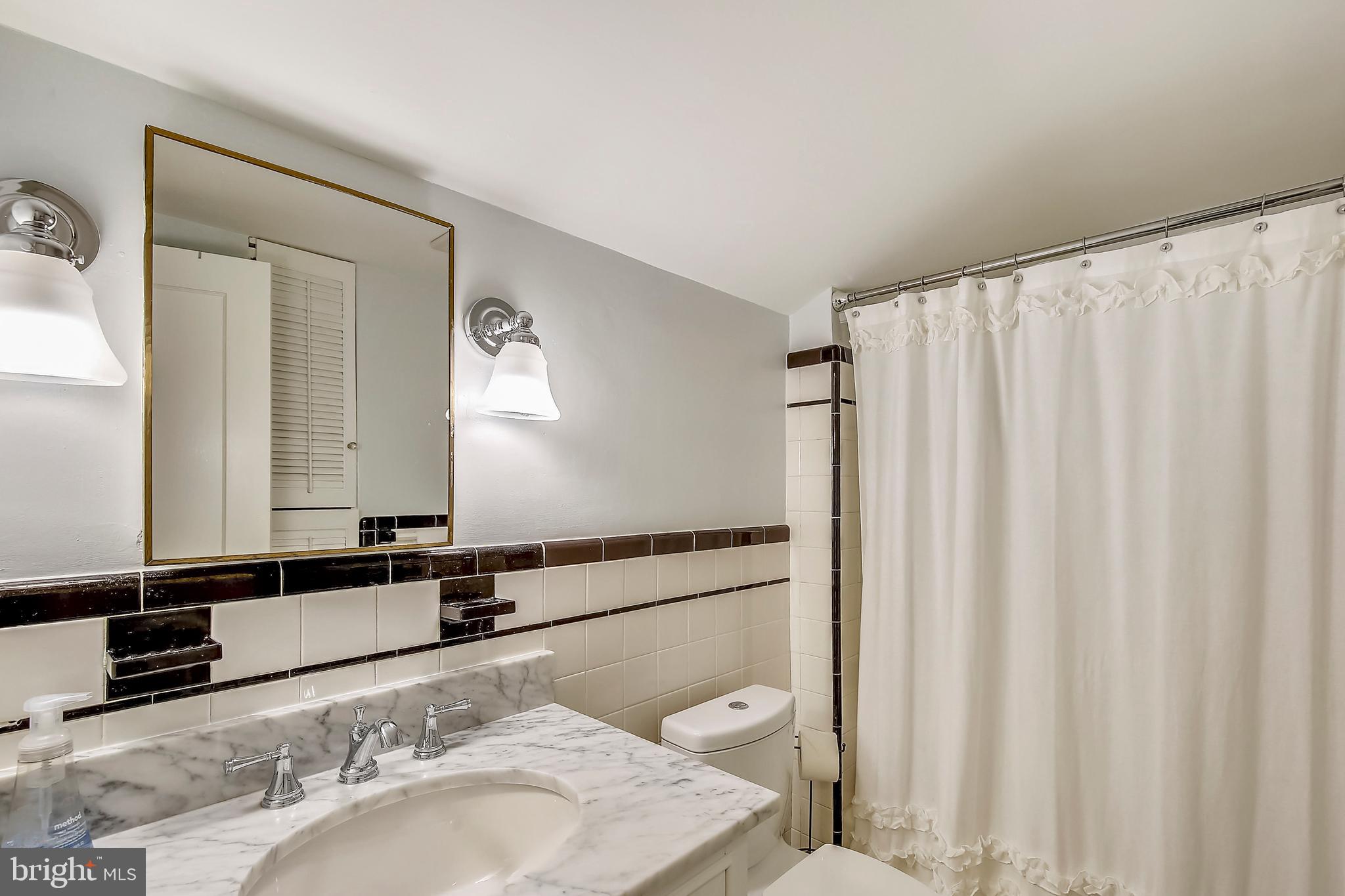9929 Woodburn Road Silver Spring, MD 20901 - Photo 23 of 33 Hall Bath upstairs with new vanity and lighting