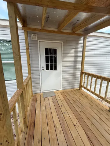 a view of a room with wooden floor and window