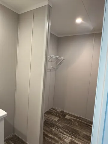 a view of an empty room and wooden floor