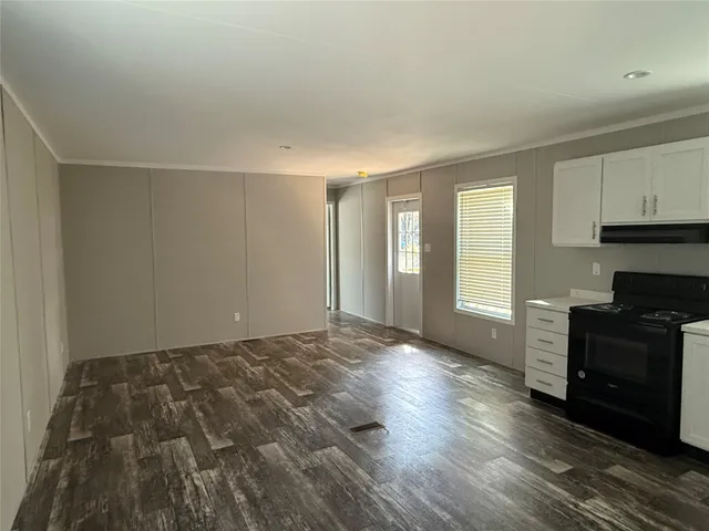 a view of a balcony with wooden floor and fence