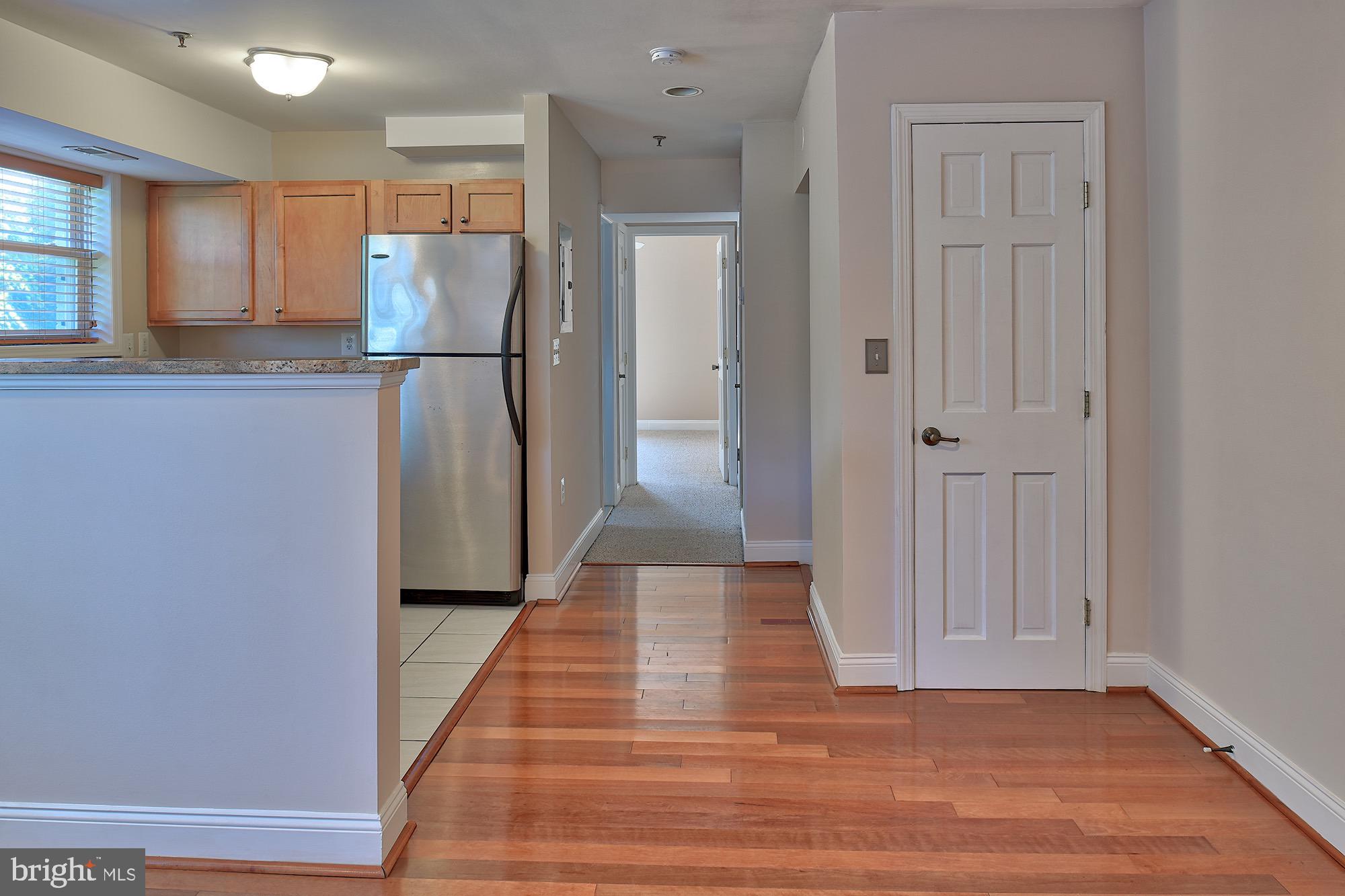 a view of a refrigerator in kitchen and wooden floor