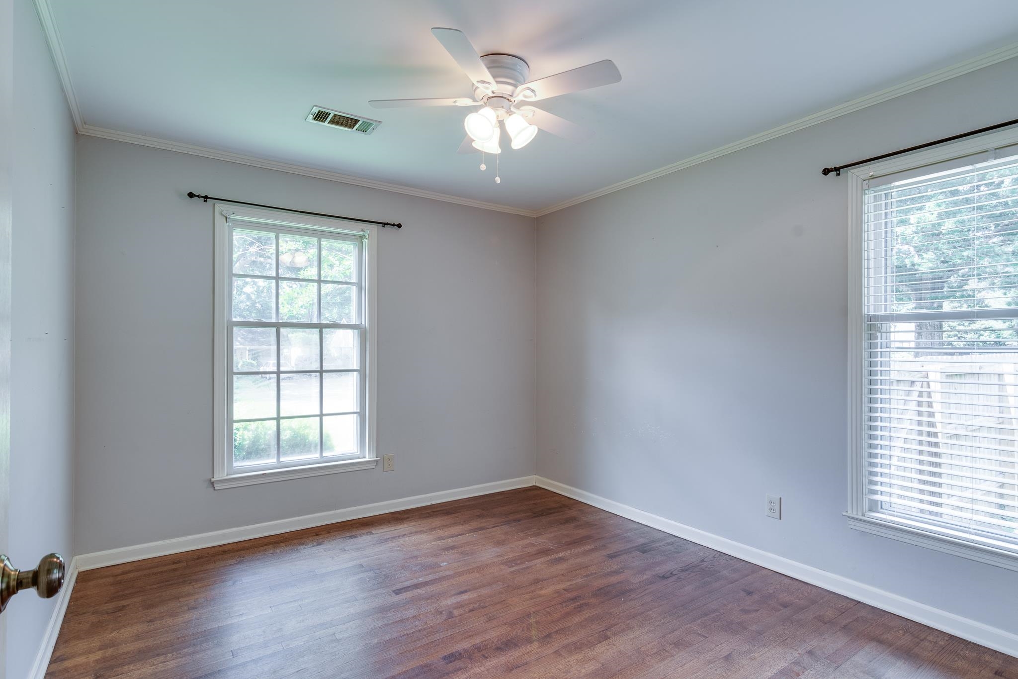 4978 Chickasaw Road Memphis, TN 38117 - Photo 18 of 28 an empty room with wooden floor and windows