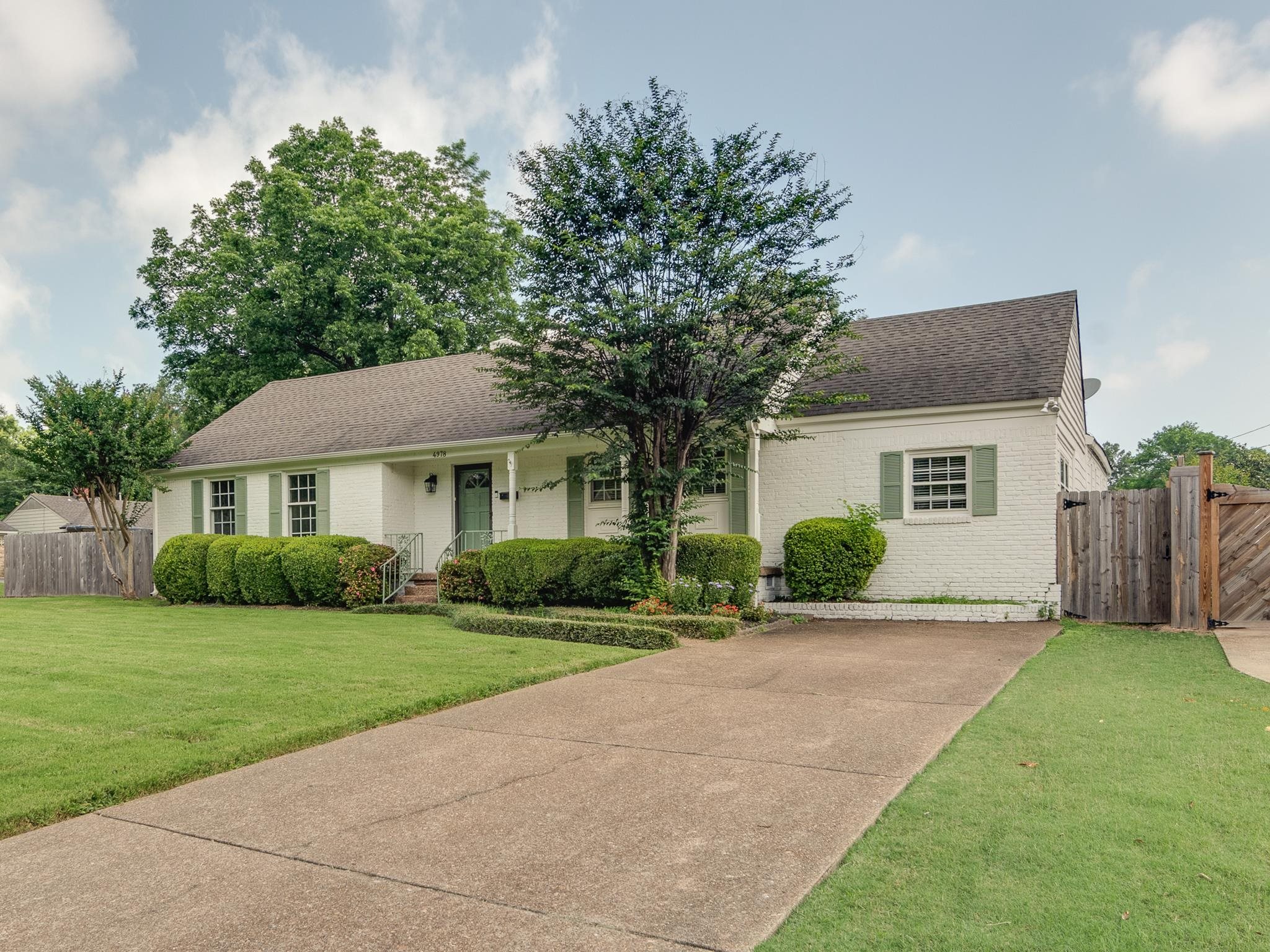 4978 Chickasaw Road Memphis, TN 38117 - Photo 2 of 28 a front view of a house with a garden and yard