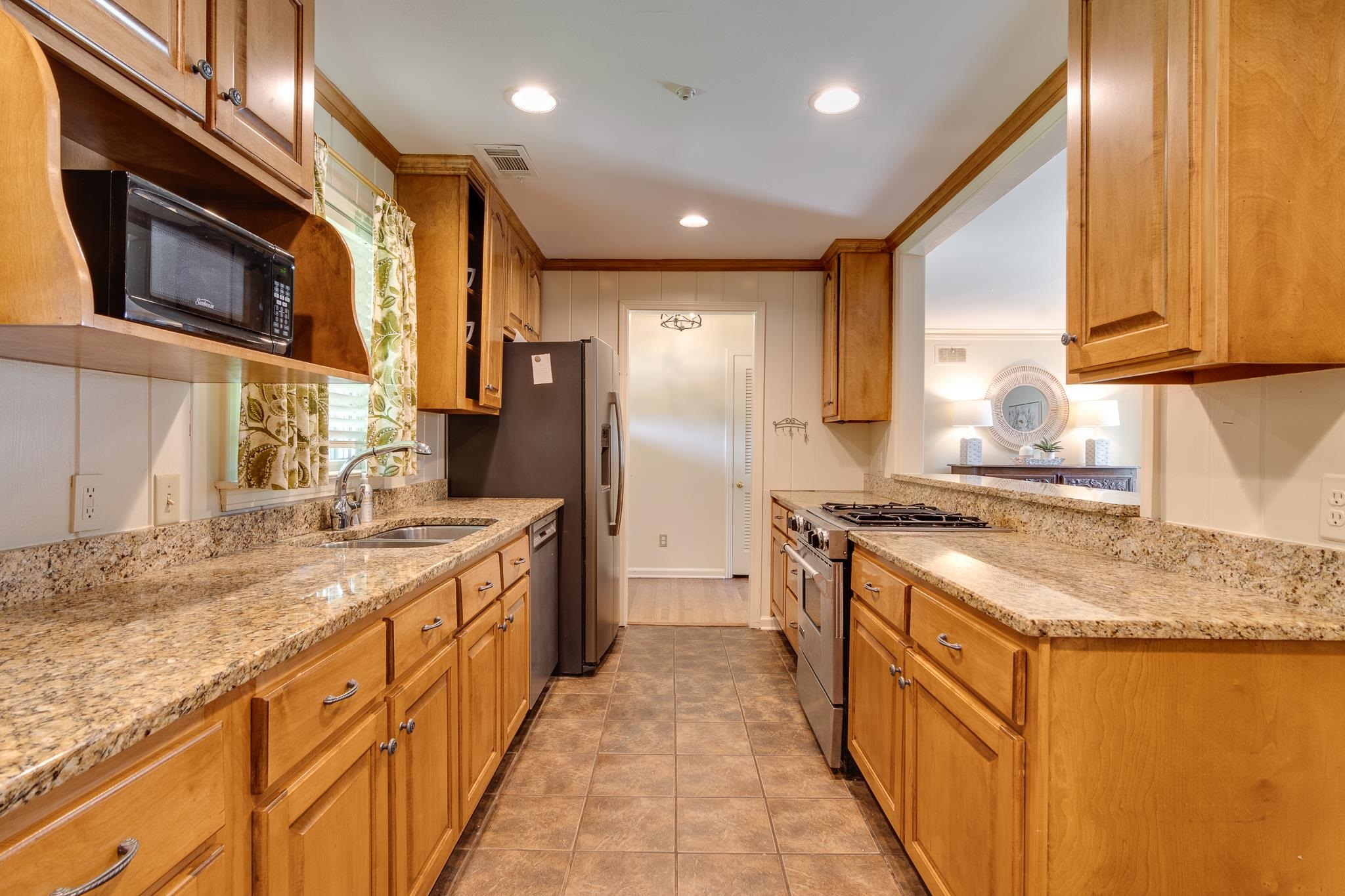 4978 Chickasaw Road Memphis, TN 38117 - Photo 9 of 28 a kitchen with stainless steel appliances granite countertop a sink stove and refrigerator