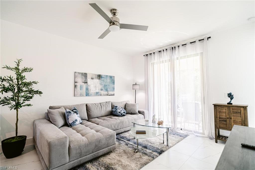 907 Homestead Road South Lehigh Acres, FL 33974 - Photo 16 of 43 Bright living space featuring large-format tile flooring and a ceiling fan
